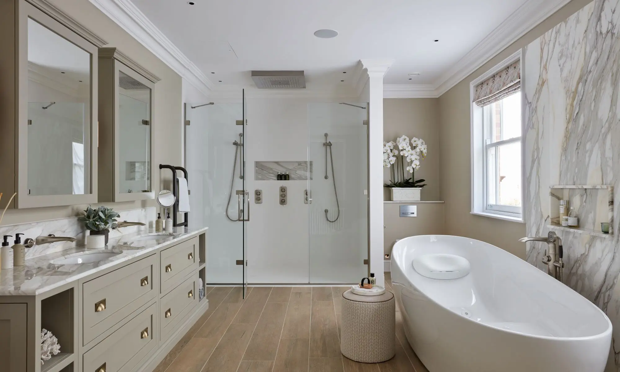 A bathroom with a large tub and walk in shower.