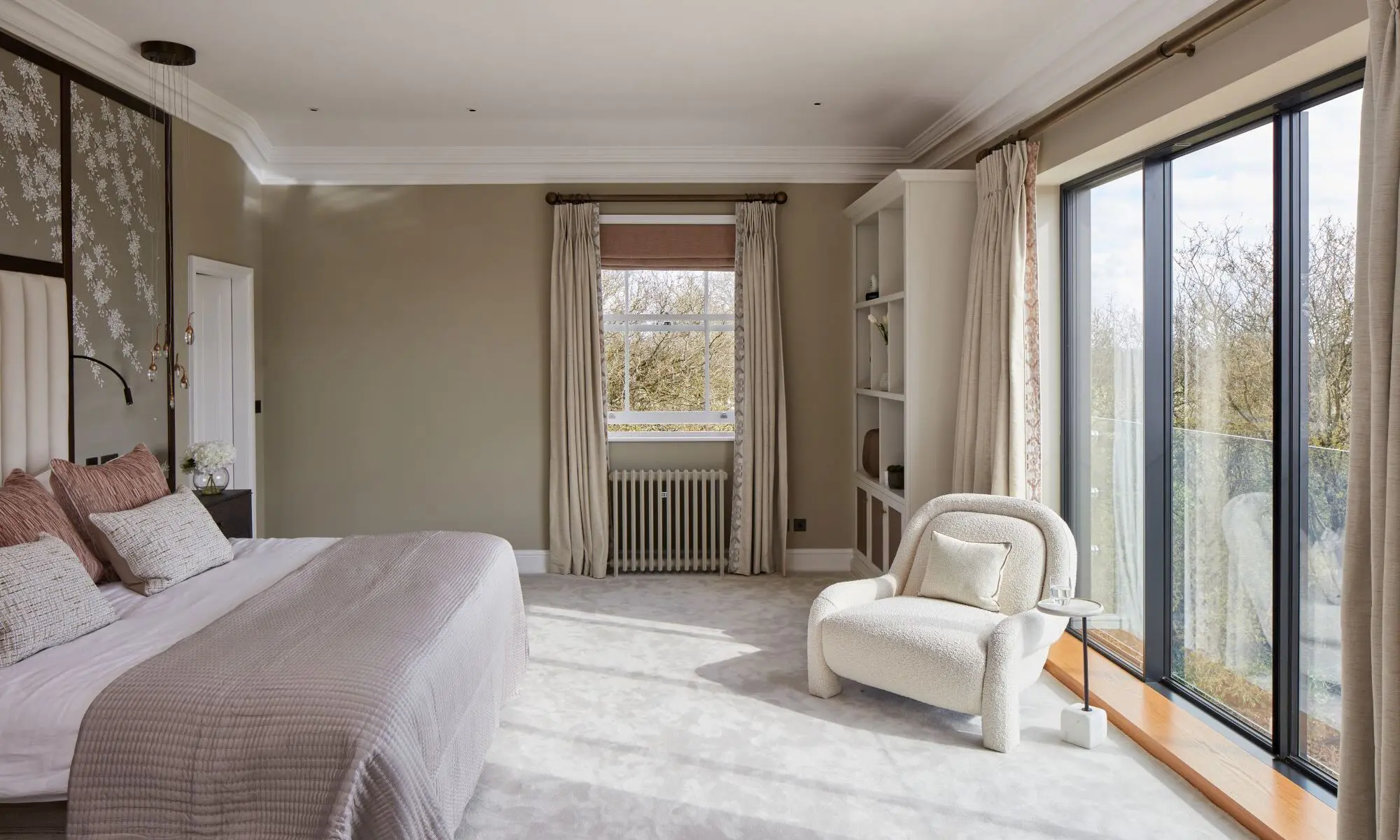 A bedroom with a bed and a chair.