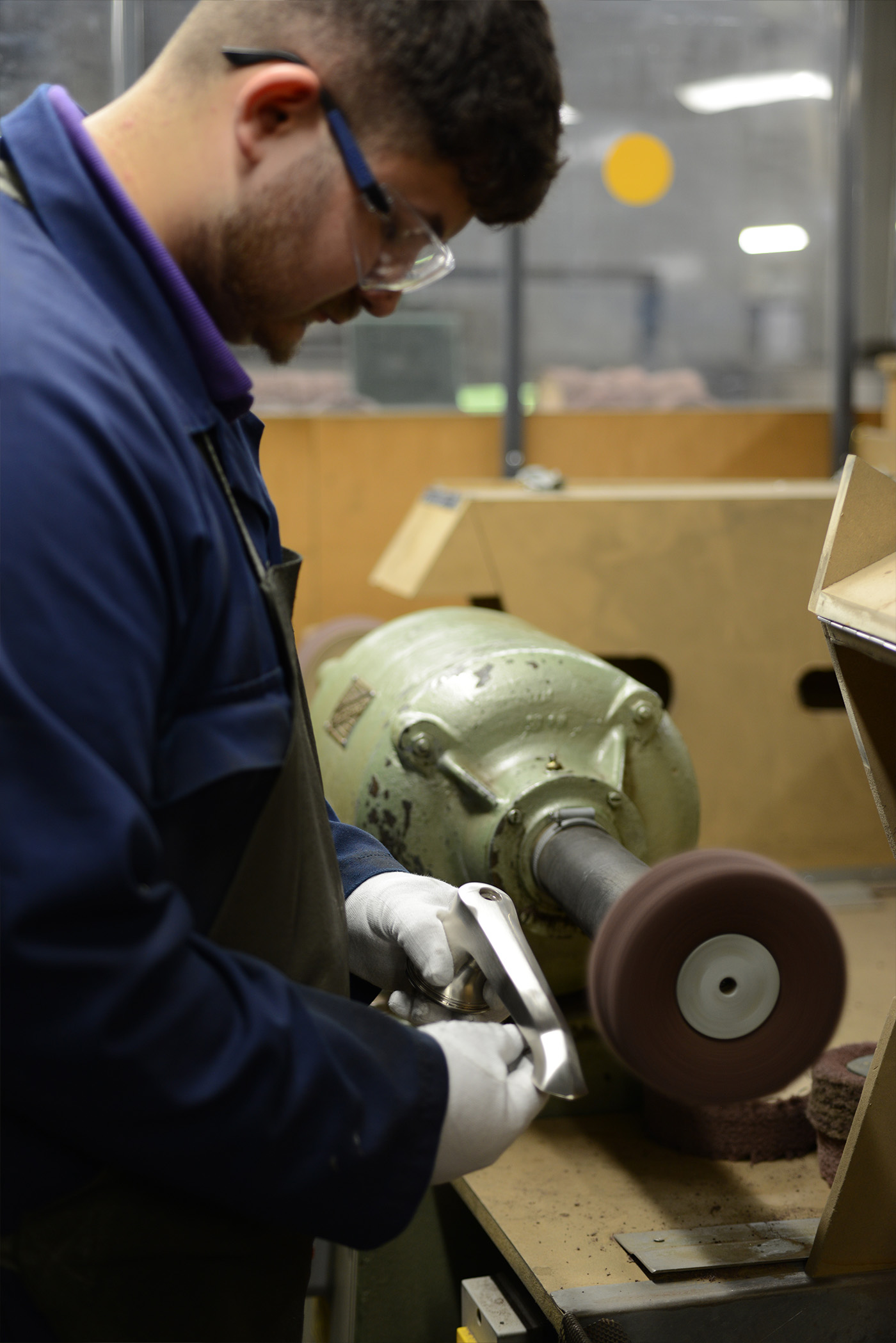 A young Polisher inspecting a basin spout that has just been brushed