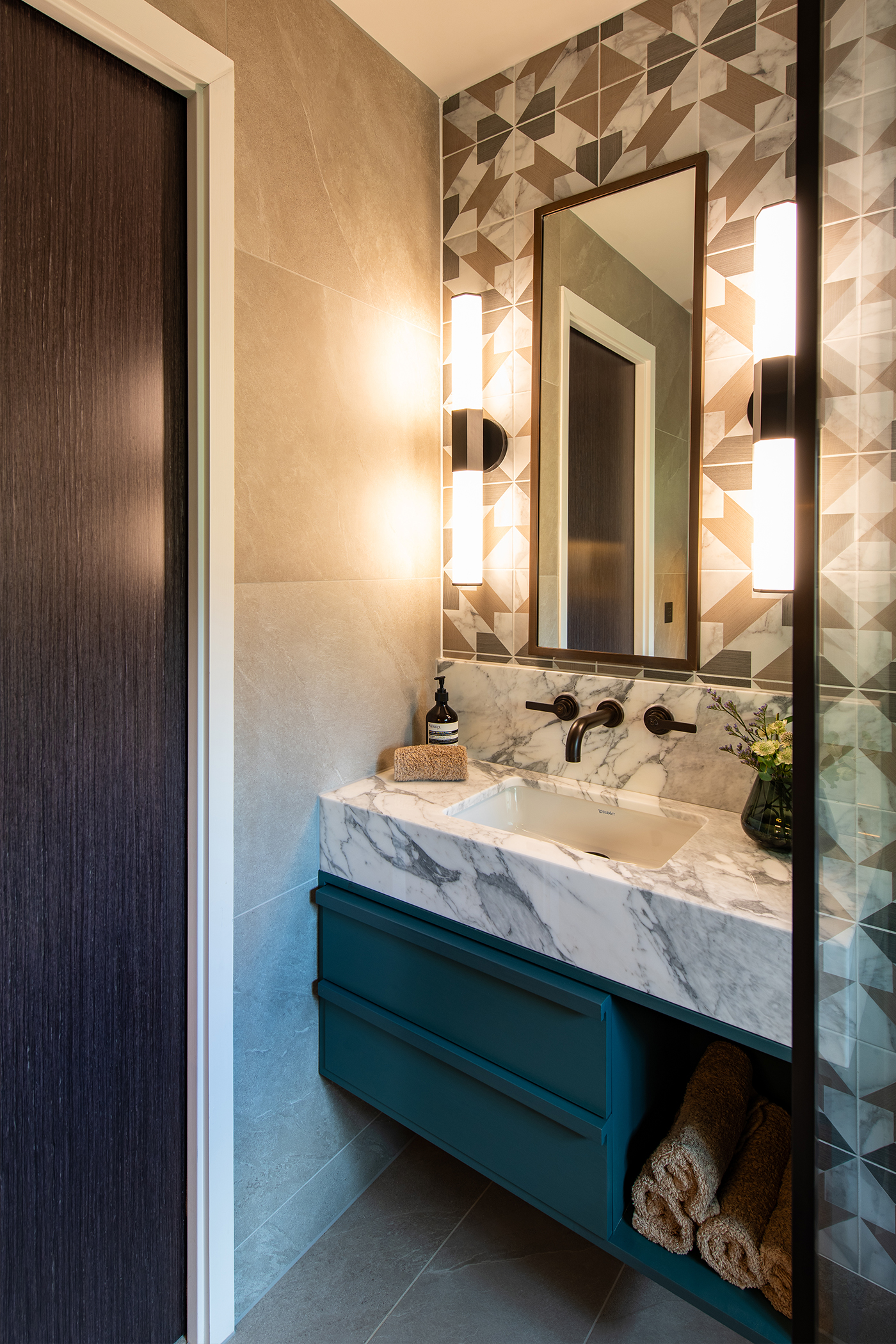 Youngest son's ensuite with geometric tiles bespoke marble vanity and Landmark Pure basin tap by Samuel Heath