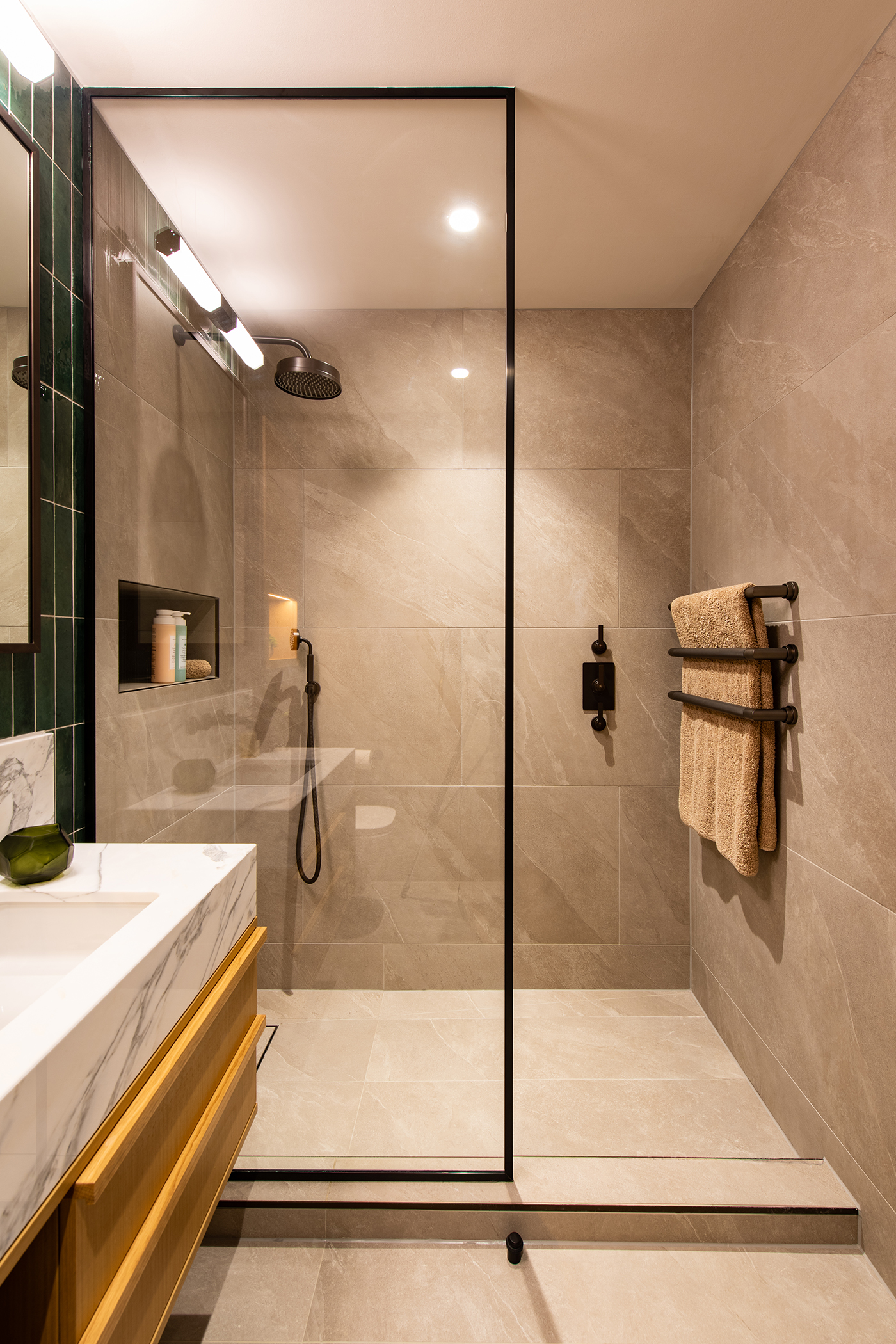 Older son's ensuite with light brown tiled walls and Landmark Pure concealed shower set by Samuel Heath