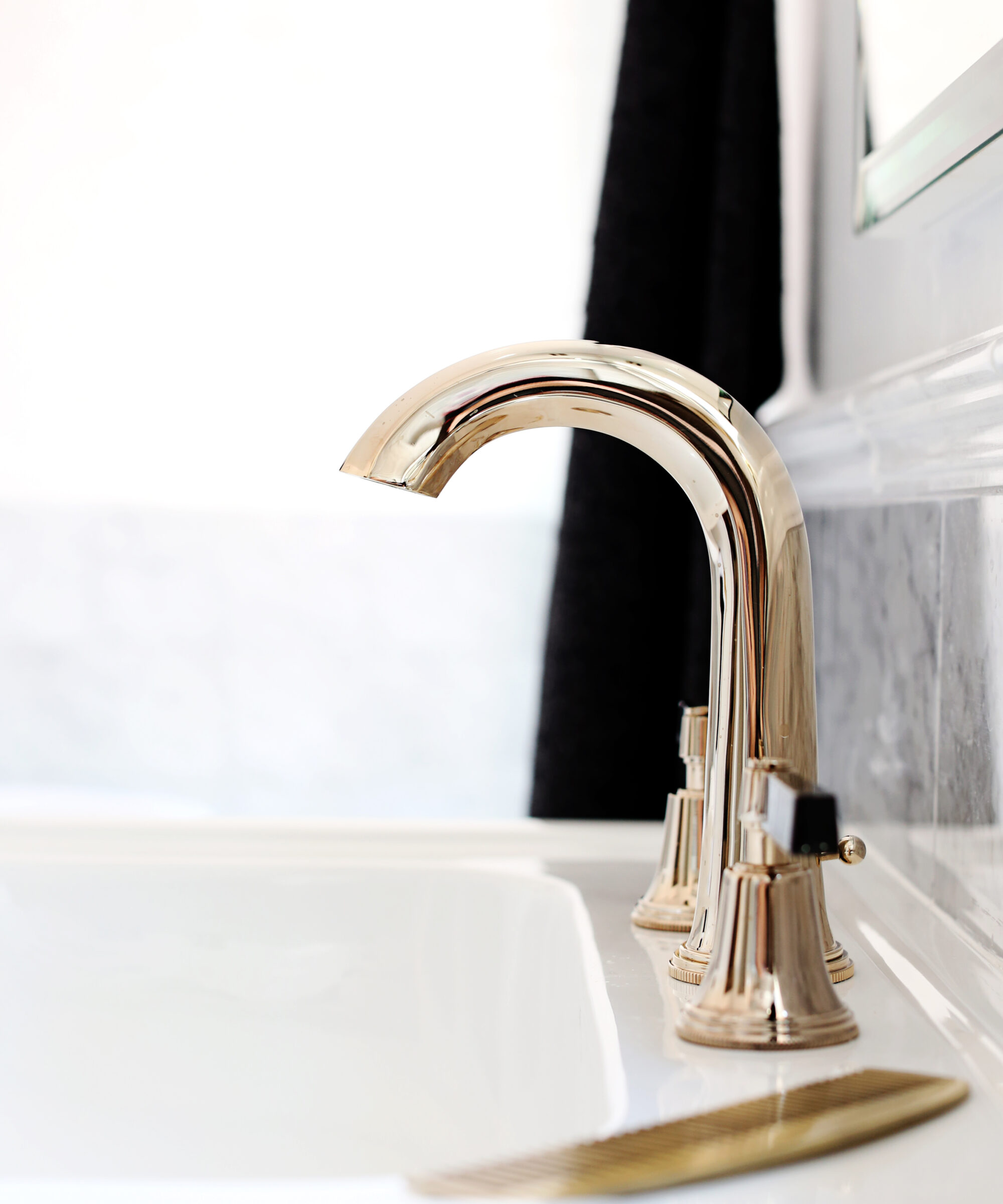 Luxury Art Deco taps mounted on a white basin