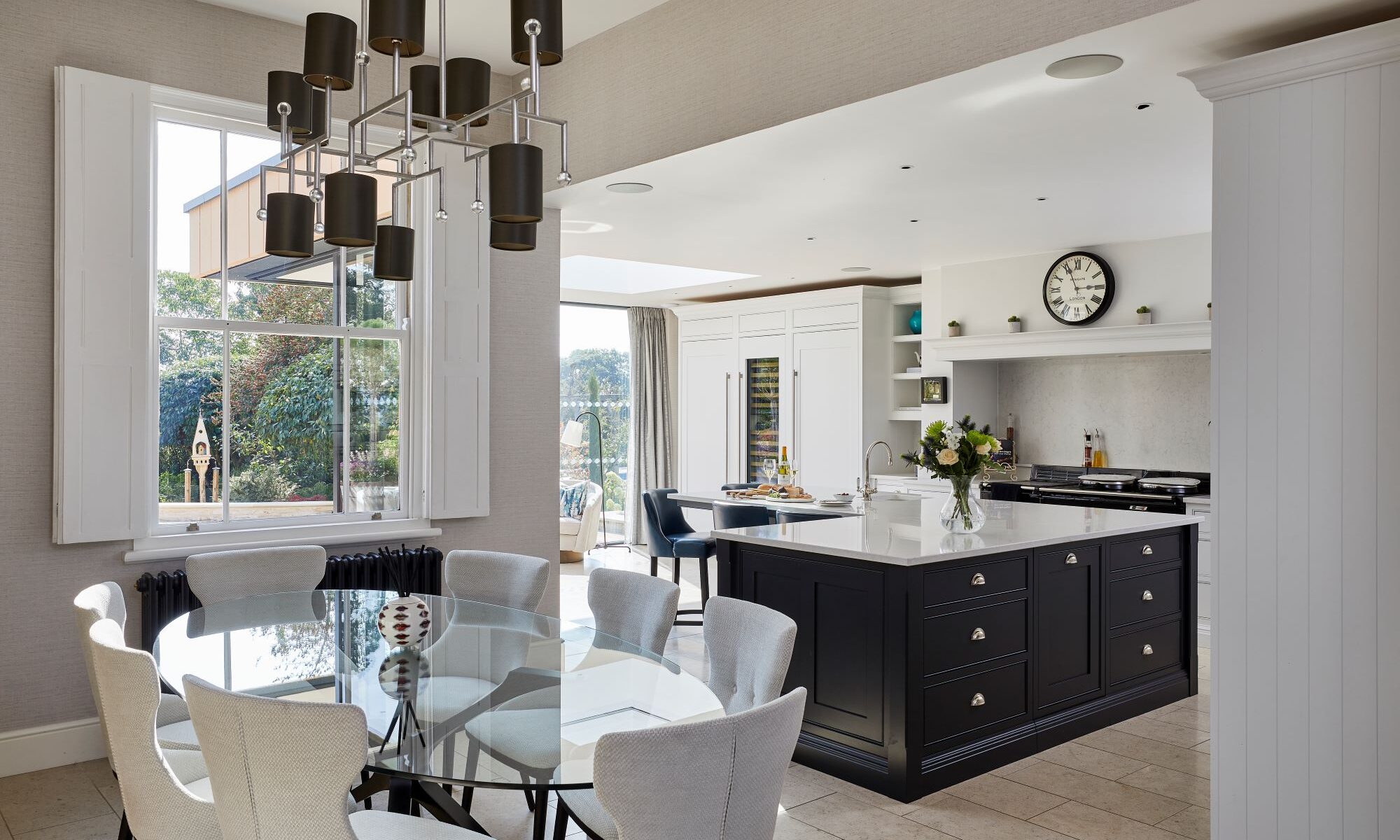 A kitchen with a dining table and chairs.