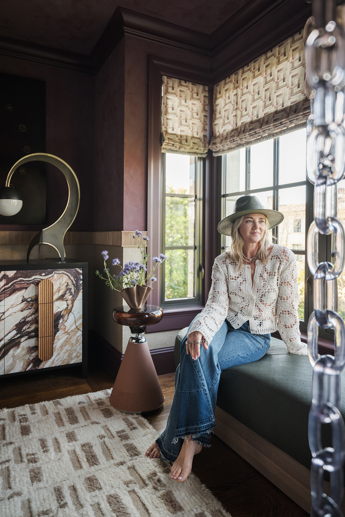 Kendra of Nash Design Group in the window of The Global Nest bedroom