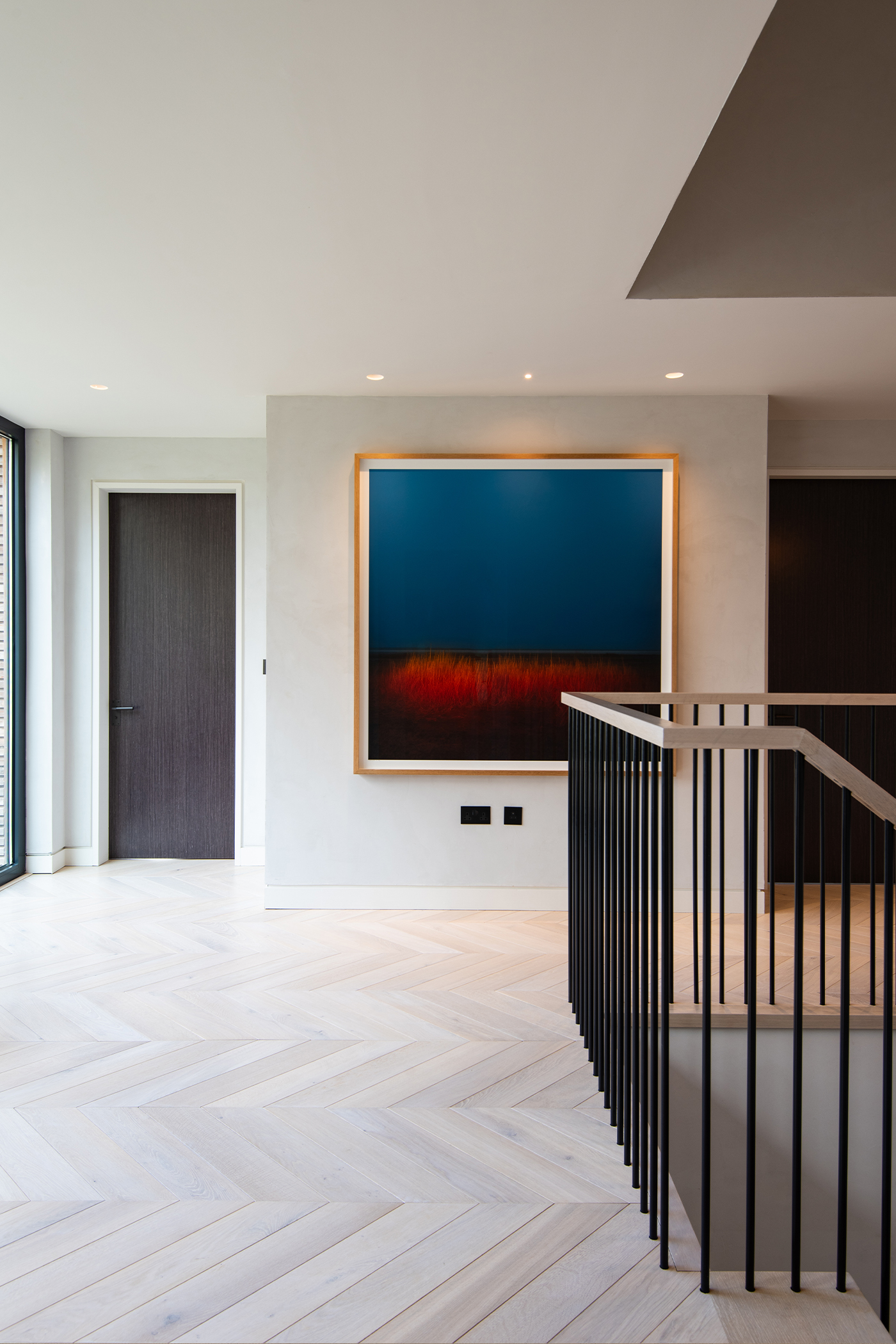 Open hallway with darg grey stair balustrade