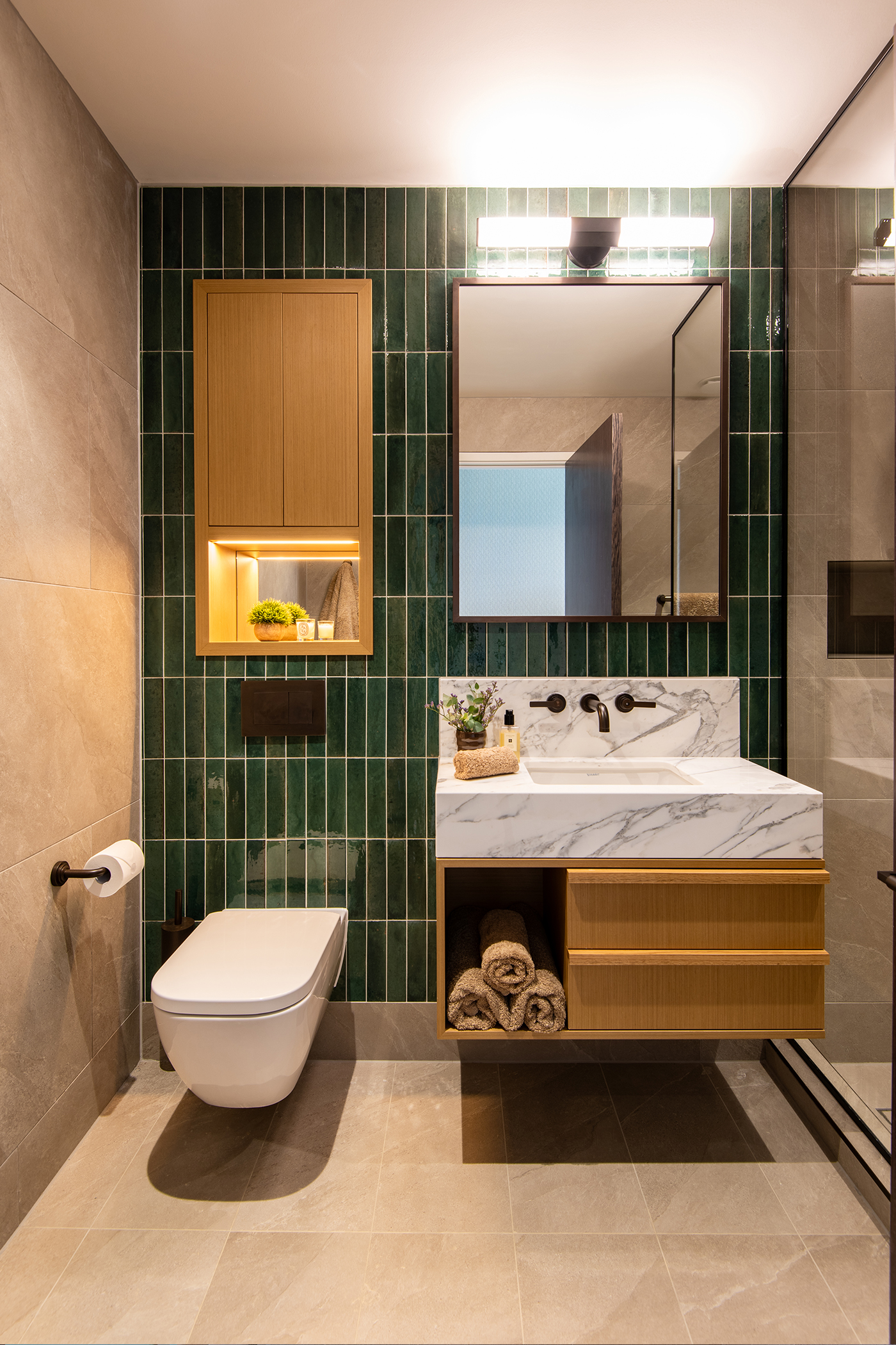 older son's ensuite with deep green tiled wall and LMK pure basin tap by samuel heath
