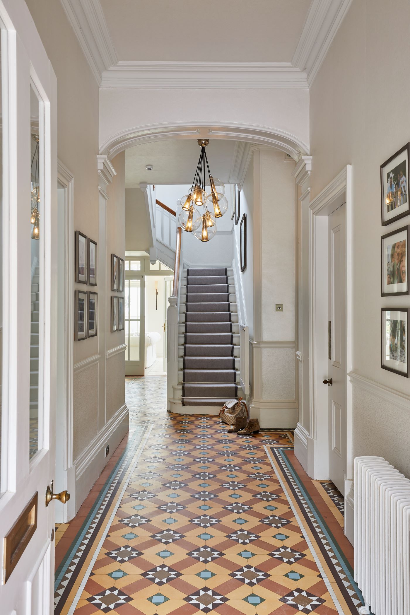 A hallway with an ornate tiled floor.