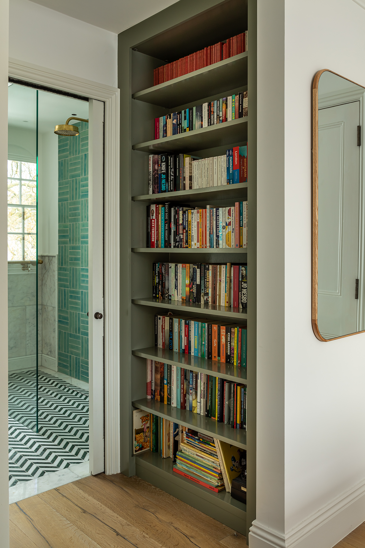 large bookcase leading to walk in shower